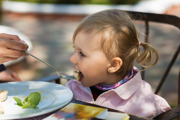 Cute little girl having a dinner