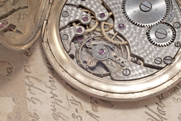 pocket-watch mechanism and old hand-written personal letter