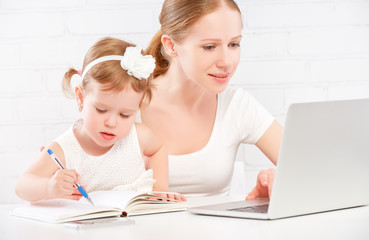 Fototapete - happy family mother and child baby at home working on computer