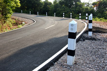 Stone Pillars Prevent Accidents On The Road Curved.
