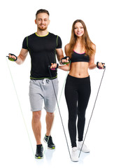 Happy athletic couple - man and woman with with ropes on the whi