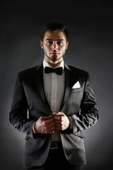 Poster - Elegant man in suit on dark background