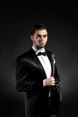 Poster - Elegant man in suit on dark background