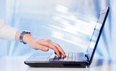 close up of man typing on laptop computer