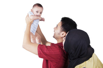 Wall Mural - Happy parents with baby boy in studio