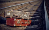 Fototapeta Zwierzęta - Old suitcases on rails