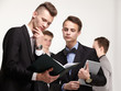 © photoniko - a group of young businessmen looking at paperwork