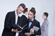 © photoniko - a group of young businessmen looking at paperwork