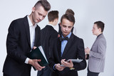 Fototapeta  - a group of young businessmen looking at paperwork