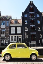 Small Yellow Car On The Building Background