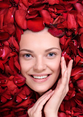 Sticker - Beautiful happy woman lying in petal of roses