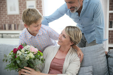 Wall Mural - Young boy giving flowers to mommy for mother's day