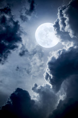 Wall Mural - dramatic nighttime clouds and sky with beautiful full blue moon