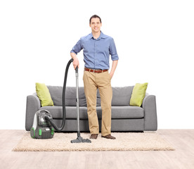 Poster - Young man posing with a vacuum cleaner