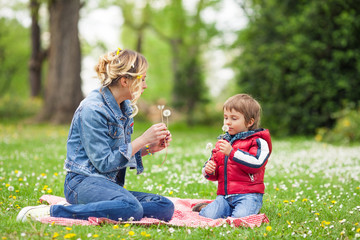 Wall Mural - Young mother and son playing in the park