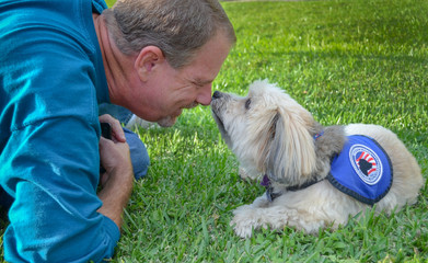 Older man sharing a precious encounter with his service dog