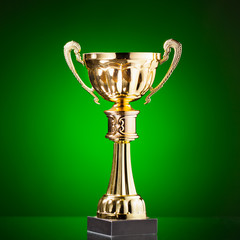 Wall Mural - gold cup trophy on green background