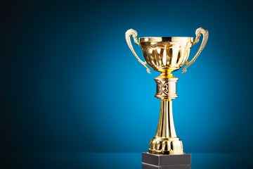 Wall Mural - gold cup trophy on blue background