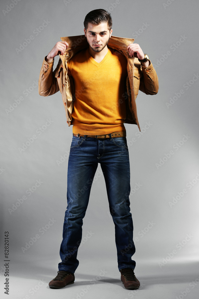 Portrait of young man on gray background