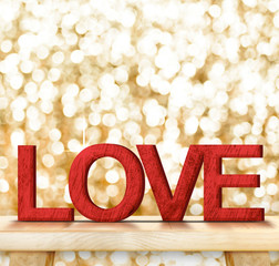 Poster - Red color LOVE word in wood texture on wooden table with gold bo