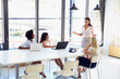 © Monkey Business - Businesswoman presenting to colleagues at a meeting