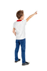 Rear view of a school boy over white background pointing upwards