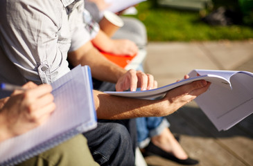 Poster - close up of students with notebooks at campus