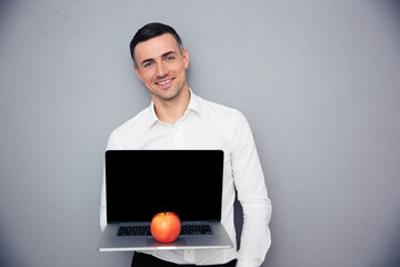 Wall Mural - Businessman showing blank laptop screen