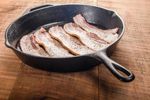 Metal Frying Pan With Strips Of Bacon