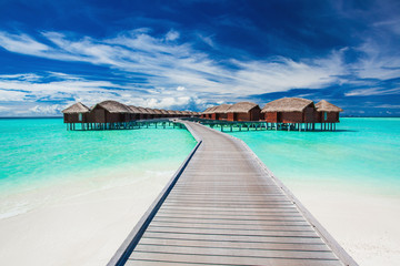 Wall Mural - overwater villas on the tropical lagoon connected by jetty