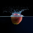 Apple falls into the water. Water splash