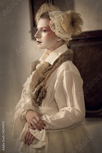Fotografie, Obraz Young blonde girl in the form of a porcelain doll