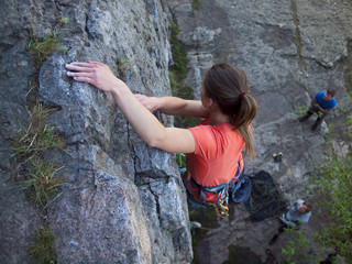 A young girl climbs the mountain.