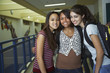 © Blend Images - Portrait of smiling girls standing together in the school hallway