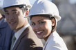 © Klaus Tiedge/Blend Images - Multi-ethnic businesspeople wearing hardhats