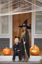Mixed Race Young Girls In Cat And Witch Costumes