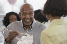 African Man Eating With Chopsticks