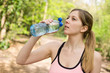 © michael spring - young fitness woman enjoying a drink of water