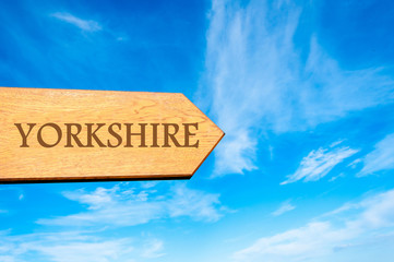 Wooden arrow sign pointing destination YORKSHIRE, ENGLAND