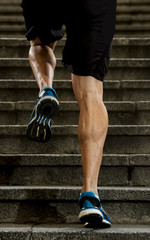 fit strong legs of sport man running steps in  urban training