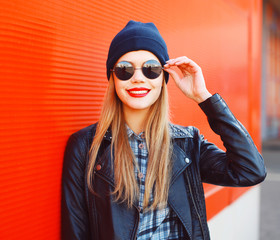 Portrait of fashionable smiling woman wearing a rock black style