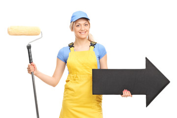 Sticker - Female painter in a yellow uniform holding a paint roller and a