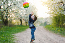 Little Boy Playing With Ball