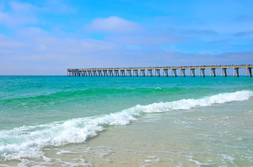 Pier stretching out over a Gulf of Mexico ocean beach