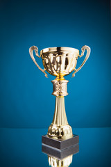 Wall Mural - gold cup trophy on blue background