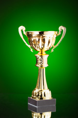 gold cup trophy on green background