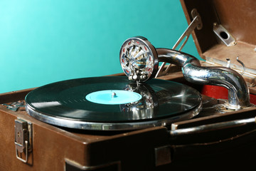 Poster - Gramophone with vinyl record on table on green background