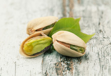 Pistachios On A Wooden Table.