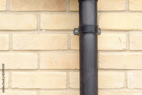 Fotografia, Obraz Close up of a black clamp on a drainpipe