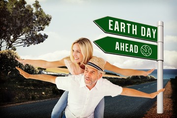 Poster - Composite image of happy man giving his partner a piggy back
